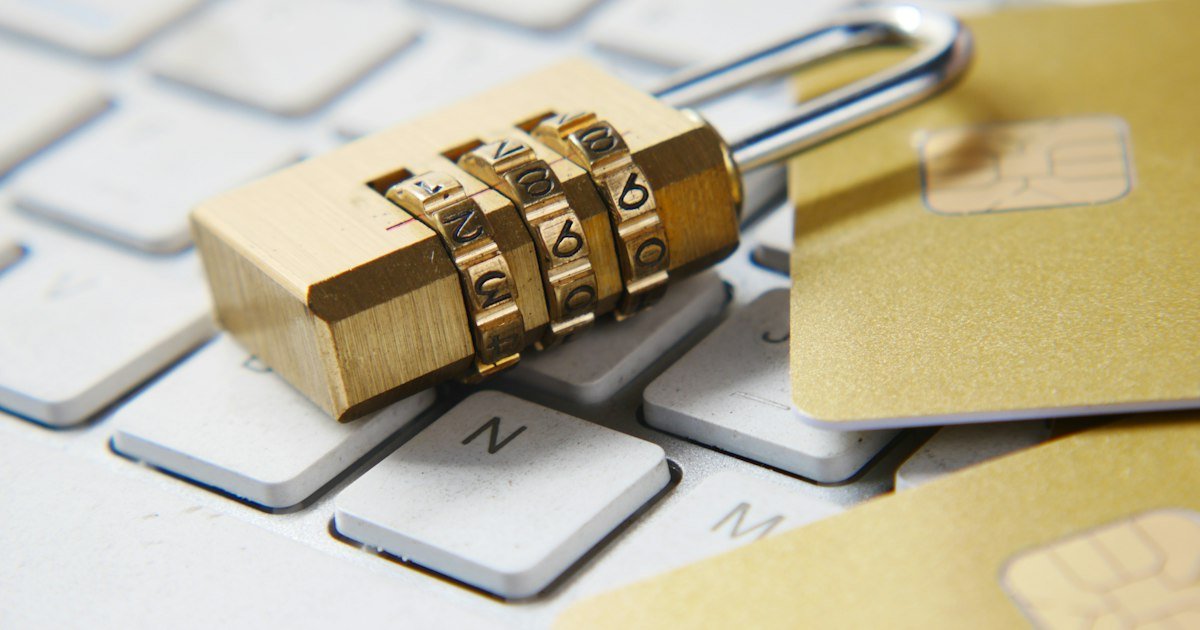 Padlock resting on a laptop keyboard, representing online privacy and security