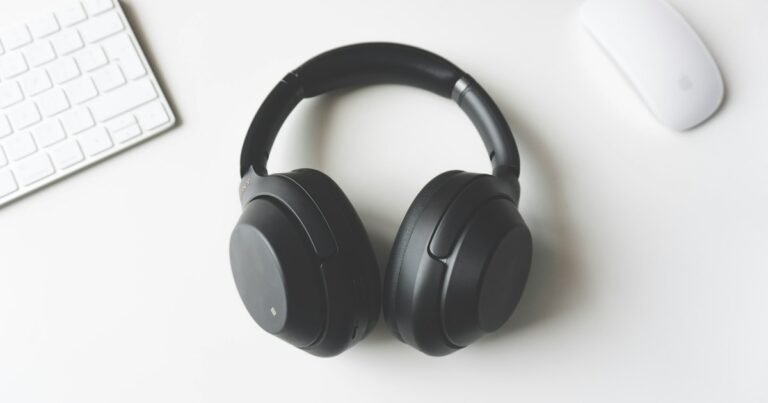 Black wireless headphones on a white desk