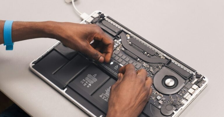 Technician repairing a laptop