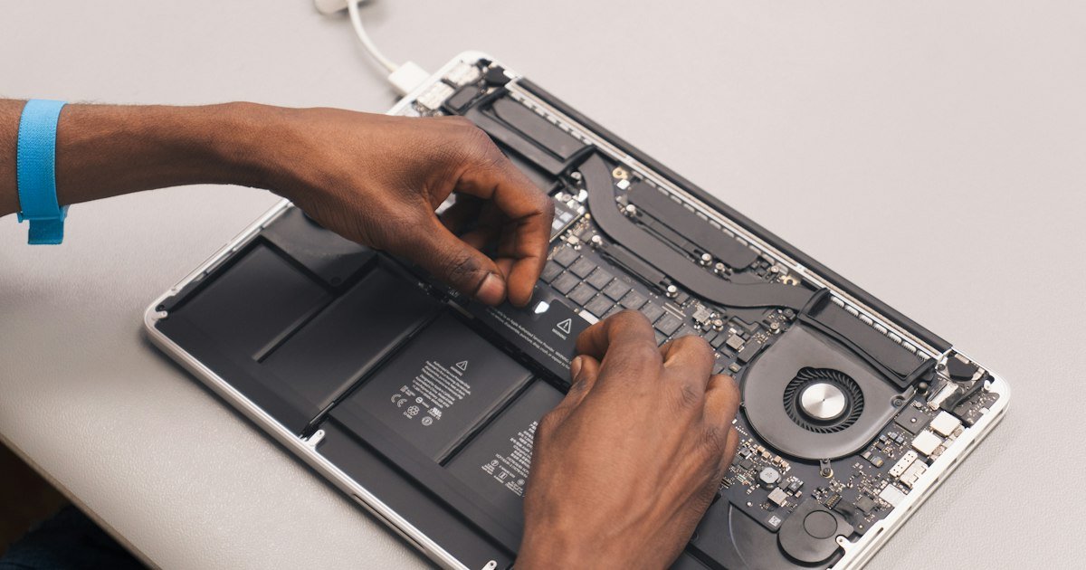 Technician repairing a laptop