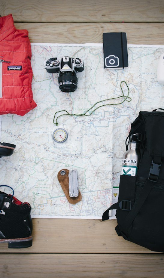 Travel and outdoor gear on a wooden table